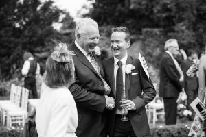 groom and his father at outdoor wedding ceremony in the cotswolds