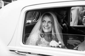 arrival of the bride in a classic car to her church wedding ceremony in winchester